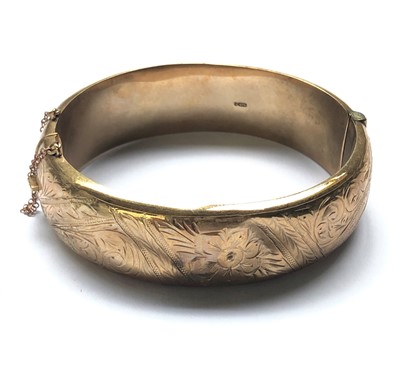 Lot 2408 - A 9ct gold hinged bangle 25.3g.