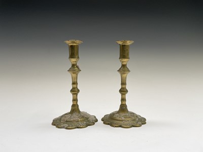 Lot 159 - A near pair of George III petal base brass...