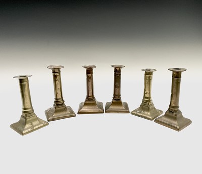 Lot 128 - Three pairs of 18th century brass candlesticks,...