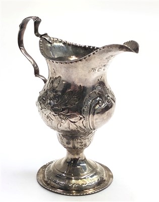 Lot 2041 - A George III silver jug with floral engraved...