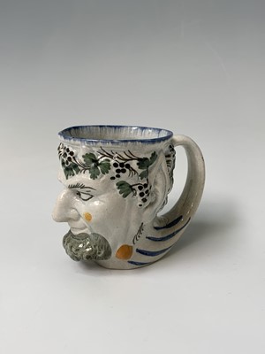Lot 110 - An English pearlware satyr jug, early 19th...