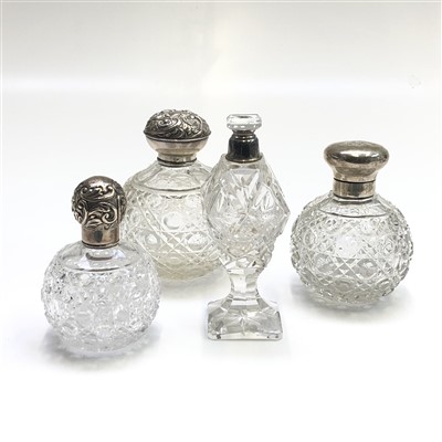 Lot 2046 - Three cut round glass toilet bottles with...
