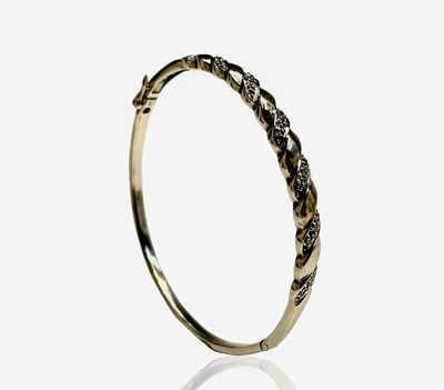 Lot 109 - A 9ct gold bangle set with diamonds 9.9gm