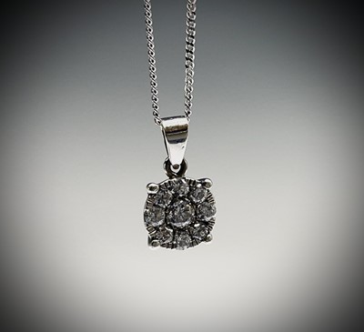 Lot 66 - A pretty 18ct white gold diamond target...