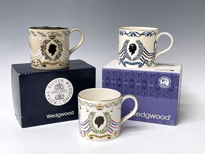Lot 828 - Three Wedgwood commemorative mugs designed...