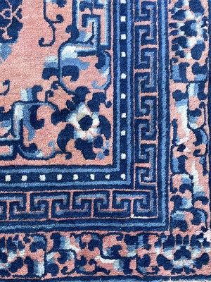 Lot 1252 - A Chinese rug, mid 19th century, the peach...