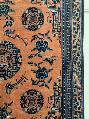 Lot 1252 - A Chinese rug, mid 19th century, the peach...