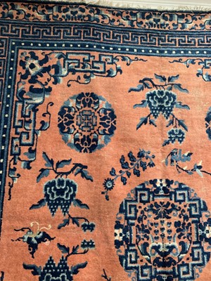 Lot 1252 - A Chinese rug, mid 19th century, the peach...