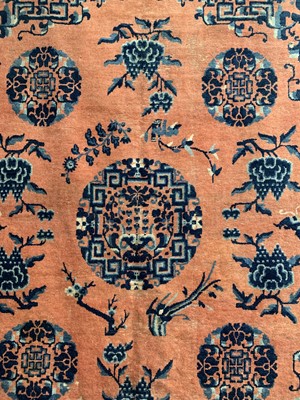 Lot 1252 - A Chinese rug, mid 19th century, the peach...