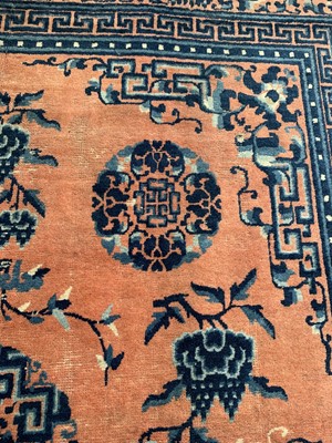 Lot 1252 - A Chinese rug, mid 19th century, the peach...