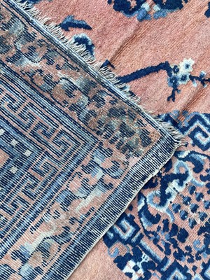 Lot 1252 - A Chinese rug, mid 19th century, the peach...