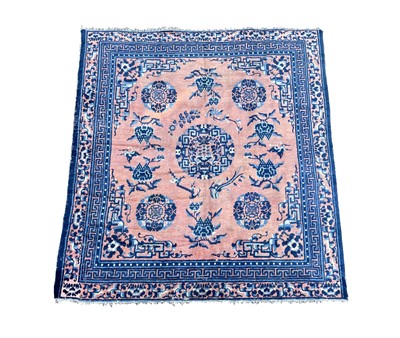 Lot 1252 - A Chinese rug, mid 19th century, the peach...