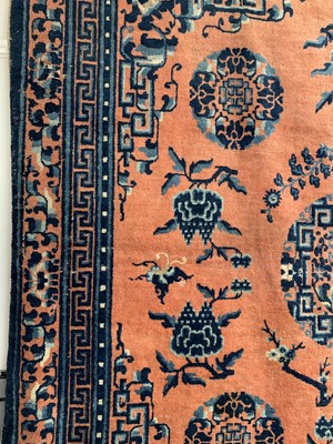 Lot 1252 - A Chinese rug, mid 19th century, the peach...