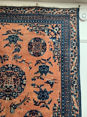 Lot 1252 - A Chinese rug, mid 19th century, the peach...