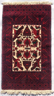 Lot 3104 - A Belouch rug, the ivory field with stylised...
