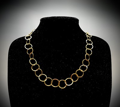 Lot 42 - A contemporary, artist made 18ct gold hammered...