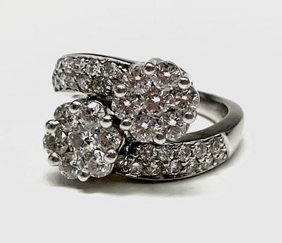 Lot 105 - An 18ct white gold and diamond flowerhead...