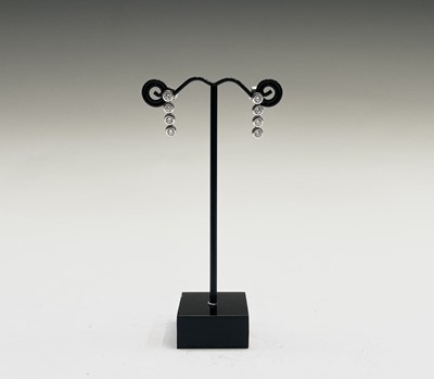 Lot 67 - A pair of 18ct white gold and diamond drop...
