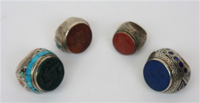 Lot 2420 - A group of four massive silver stone inlaid...