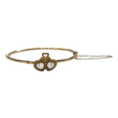 Lot 2797 - A gold bangle mounted with a pair of co-joined...