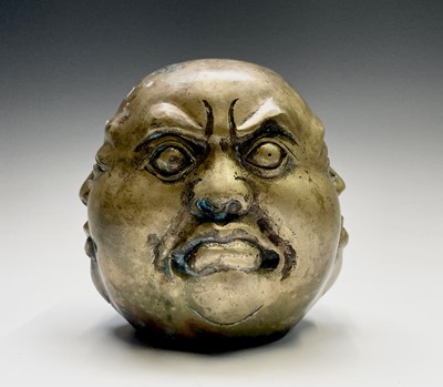 Lot 371 - A Chinese brass model of the four faces of...
