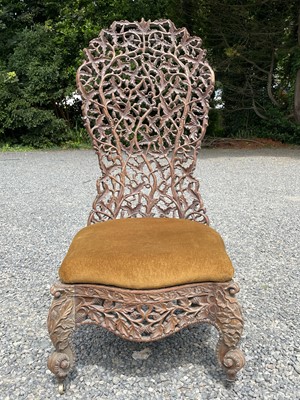 Lot 1004 - An Anglo-Indian carved teak chair, 19th...