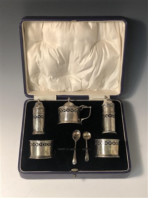 Lot 2020 - A cruet box containing various condiments and two plain napkin rings