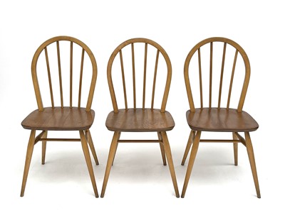 Lot 3056 - A set of three Ercol beech and light elm hoop...