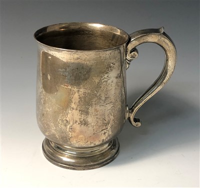 Lot 2024 - A plain bellied silver footed pint mug with...