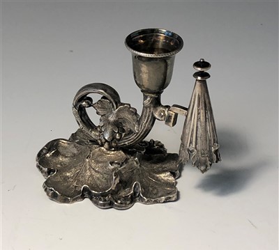 Lot 2010 - An English silver taper snuffer, on leaf embossed base