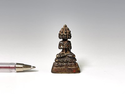 Lot 325 - A miniature bronze of a seated buddha,...