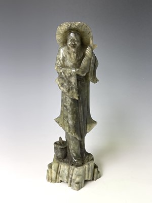 Lot 385 - A Chinese green soapstone figure, 20th century,...