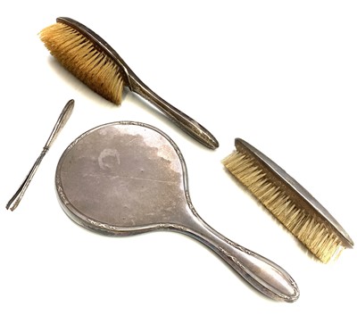 Lot 211 - A four-piece silver mounted dressing table set