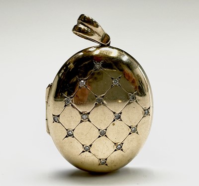 Lot 224 - A diamond set oval 9ct gold locket 16.1gm...