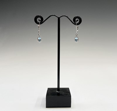 Lot 253 - A pair of aquamarine and diamond oval cluster...
