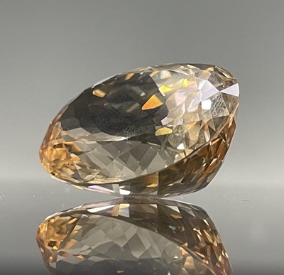 Lot 254 - An oval imperial topaz of approximately 125cts,...