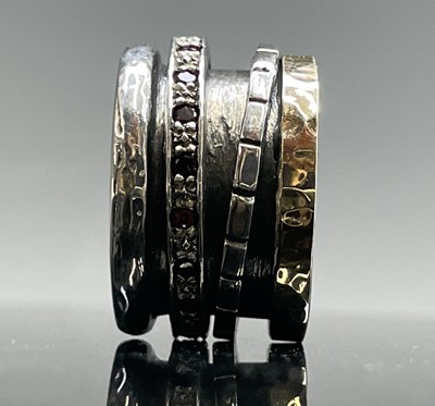 Lot 260 - A contemporary silver ring with a gold band...