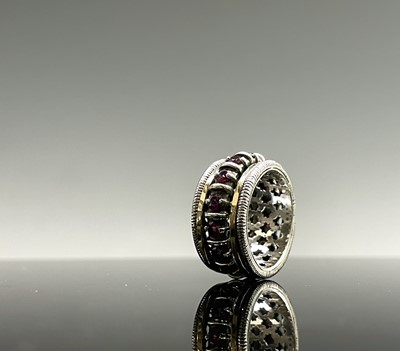 Lot 261 - A contemporary silver ring with a gold bands...