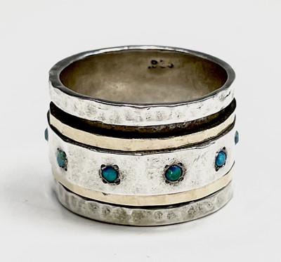 Lot 262 - A contemporary silver ring with a gold bands...