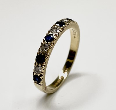 Lot 358 - An 18ct gold ring hoop set with sapphires...