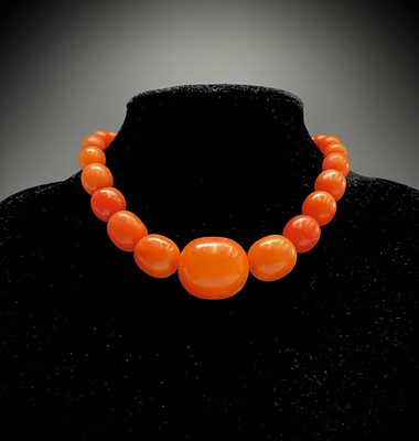 Lot 335 - An amber necklace the largest bead 25.6mm 32.9gm