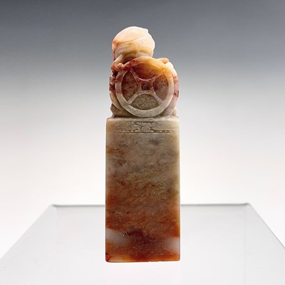 Lot 131 - A Chinese soapstone seal, surmounted by a dog...