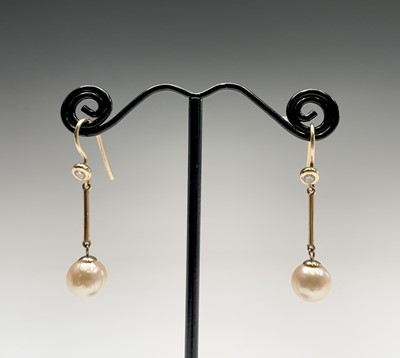 Lot 337 - A pair gold pearl and diamond earrings. The...
