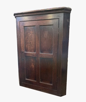 Lot 3276 - A George III oak hanging corner cupboard....