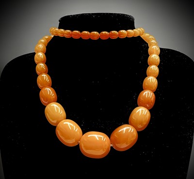 Lot 348 - An amber necklace the largest bead 25.53mm...