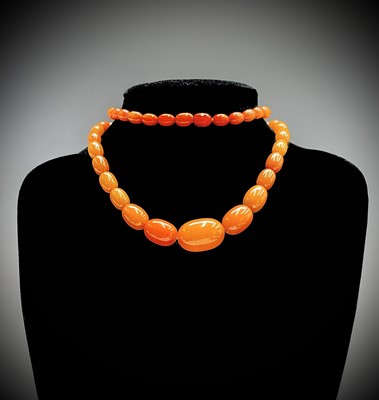 Lot 349 - An amber necklace the largest bead 24.43mm...