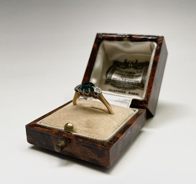 Lot 280 - An 18ct gold ring set two diamonds and a blue...
