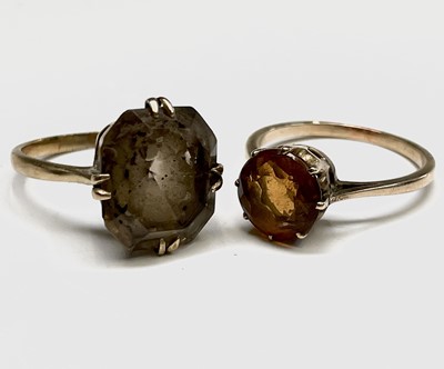 Lot 282 - A gold ring set a circular orange/brown stone...
