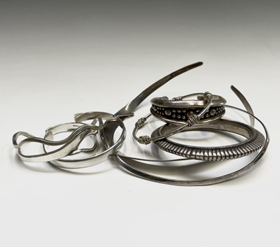 Lot 291 - Two silver torques and six silver bracelets...