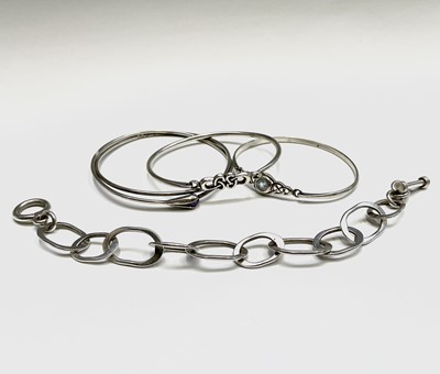 Lot 297 - Three silver bangles and a silver chain...